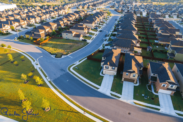 Aerial view of homes and streets in a residential neighborhood.